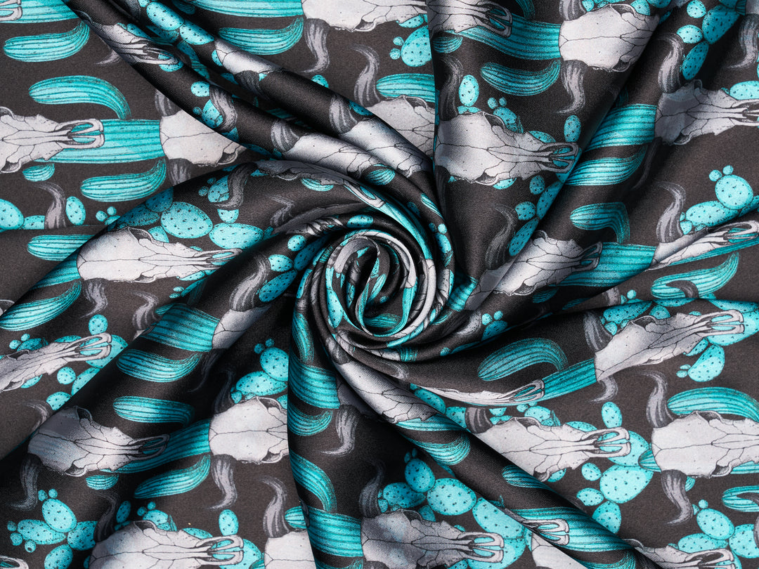 Teal cactus longhorn skull on black satin fabric