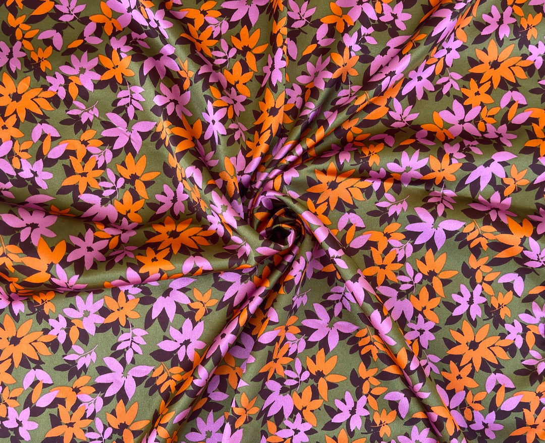 Pink orange small flowers on green background