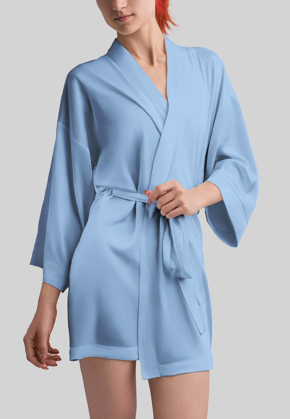 Woman wearing light blue satin robe