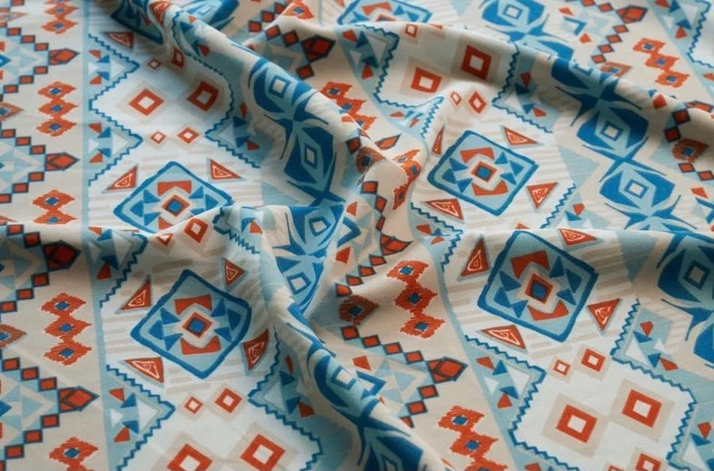 Peachskin stretch fabric by the yard - orange and blue tribal aztec