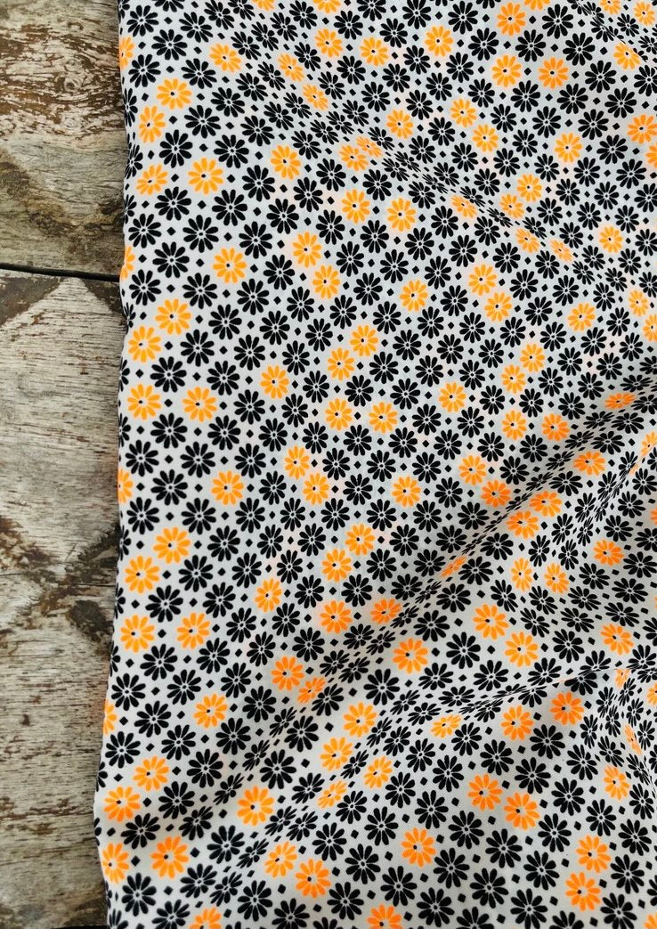 Peachskin  fabric by the yard - orange and black mini flowers