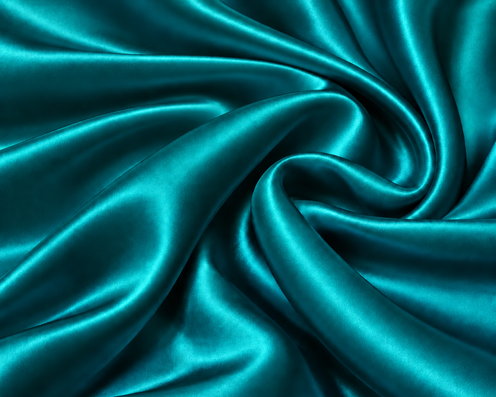Teal satin fabric draped in elegant swirls, showcasing a smooth, glossy texture with rich folds and highlights.