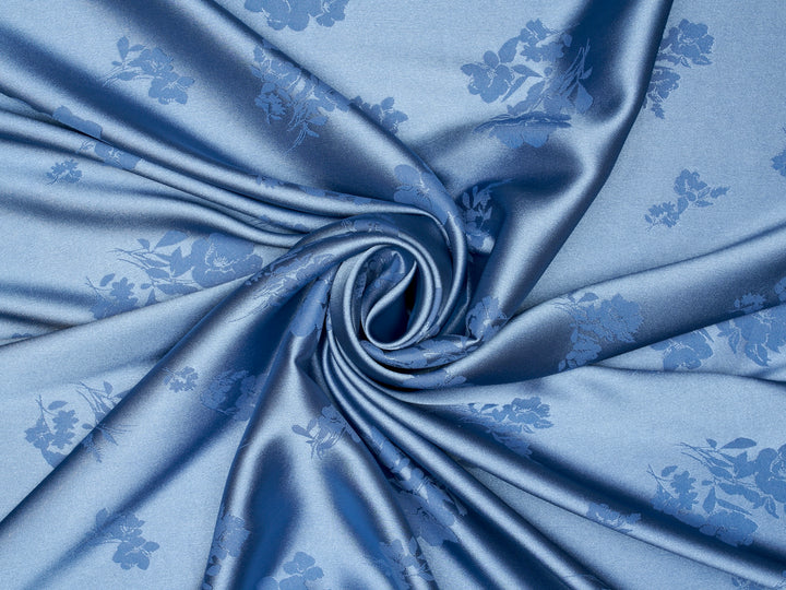 Blue fabric with floral patterns in folds