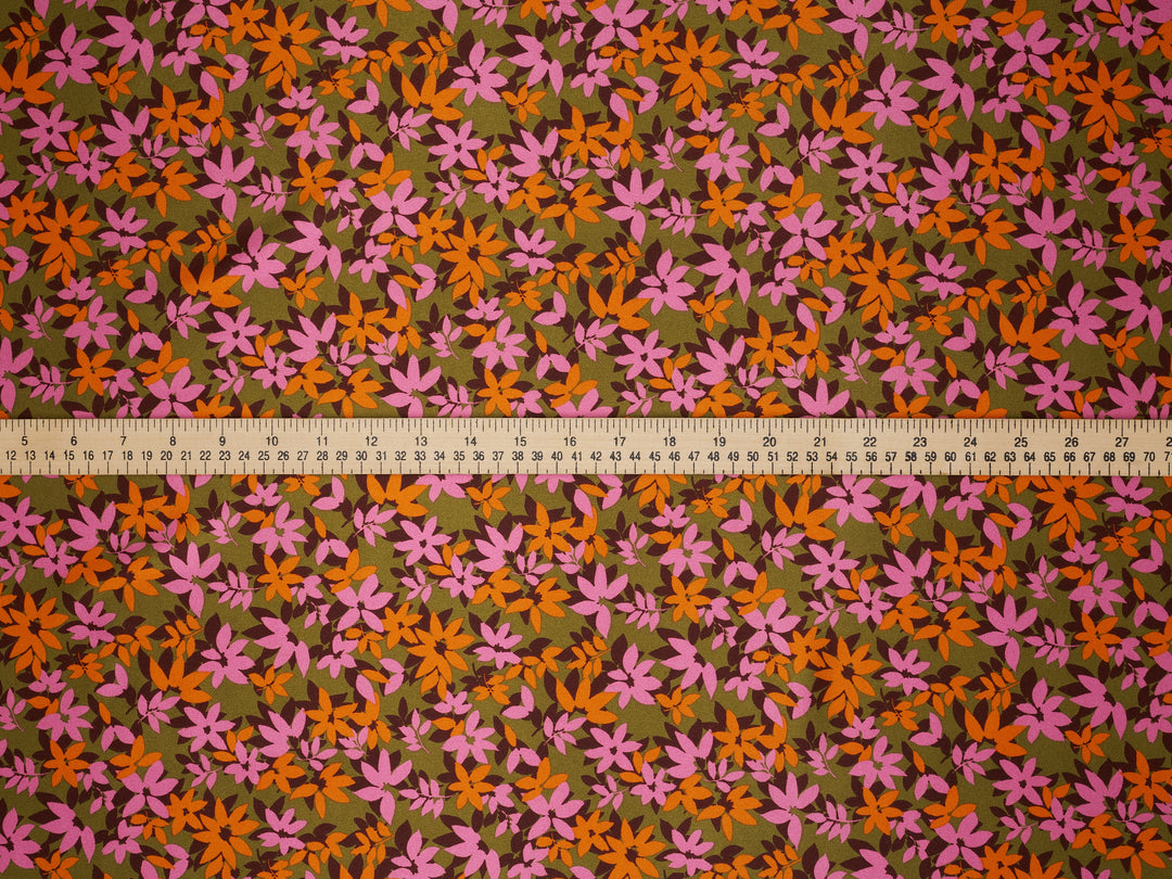 Floral patterned fabric with a ruler at the bottom for scale.