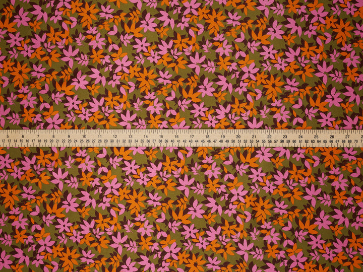 Floral patterned fabric with a ruler at the bottom for scale.