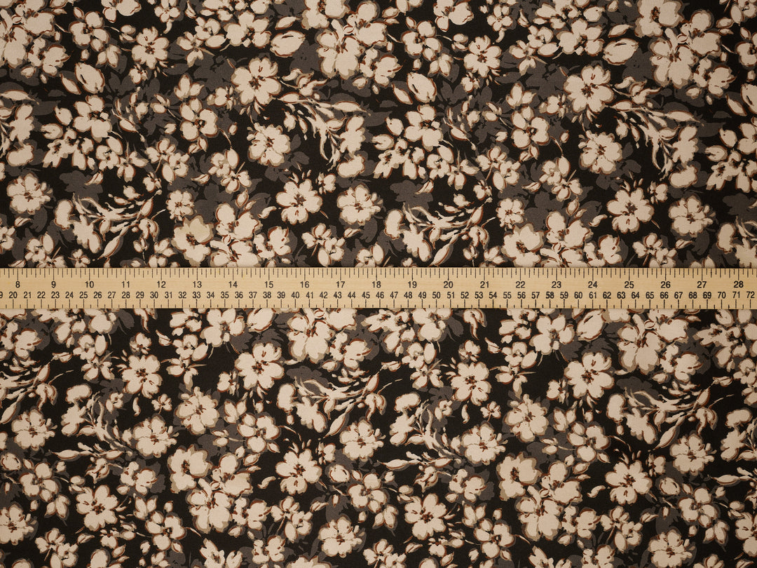 Floral patterned fabric with a ruler at the bottom for scale.