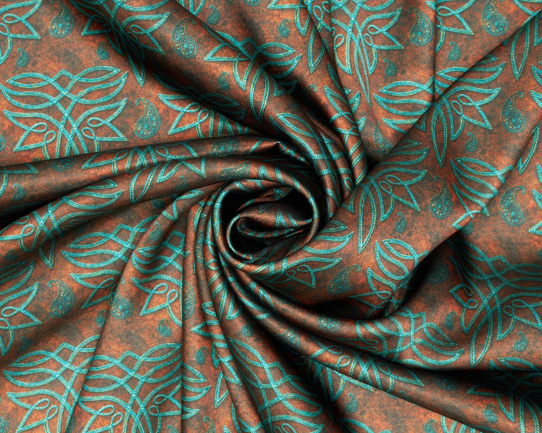 Fabric with teal leaf pattern on a rust-colored background