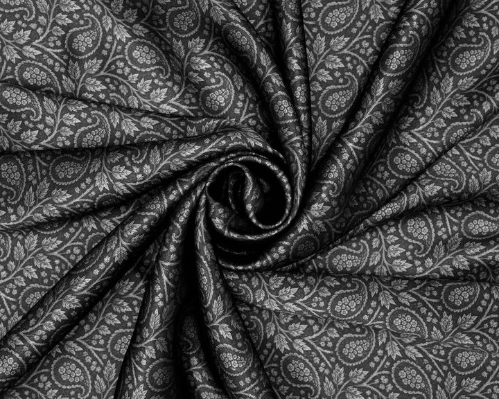Close-up of black fabric with a subtle black and white paisley pattern