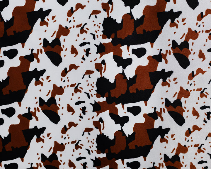 Camouflage pattern with brown, black, and white colors on a textured background