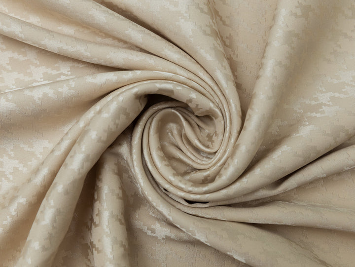 Close-up of beige fabric with a subtle pattern