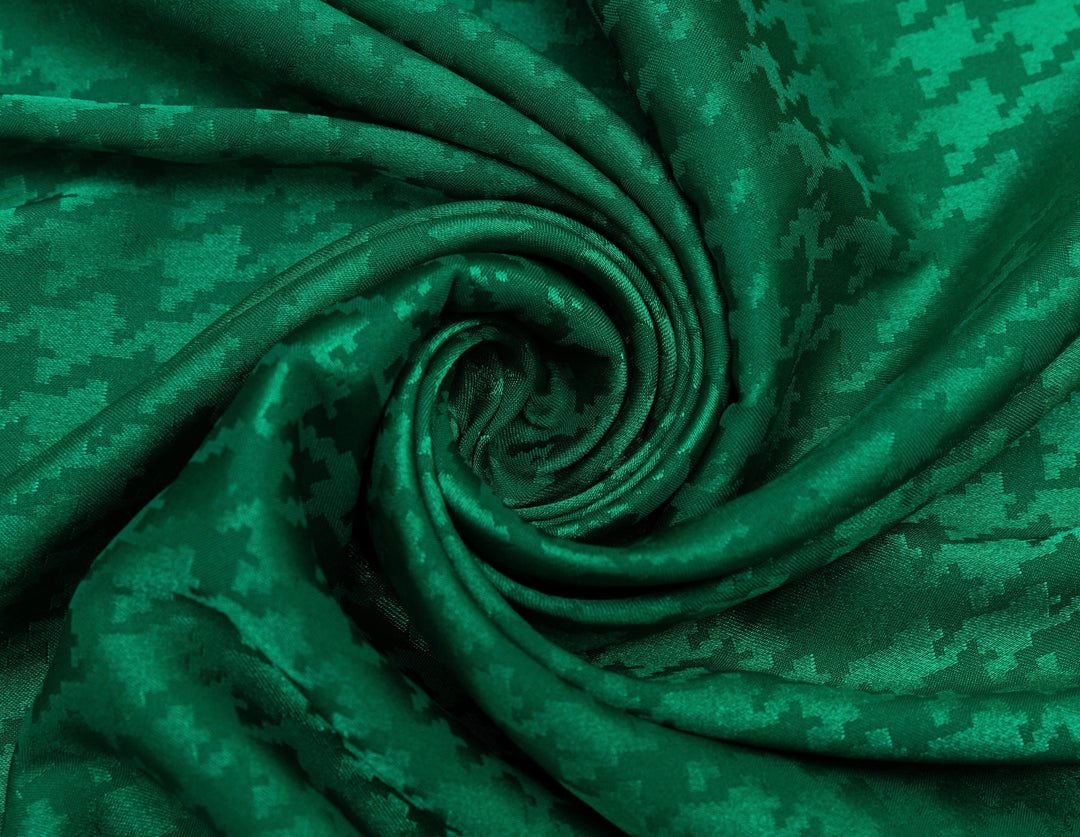 Close-up of green fabric with a digital camouflage pattern