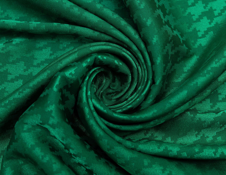 Close-up of green fabric with a digital camouflage pattern
