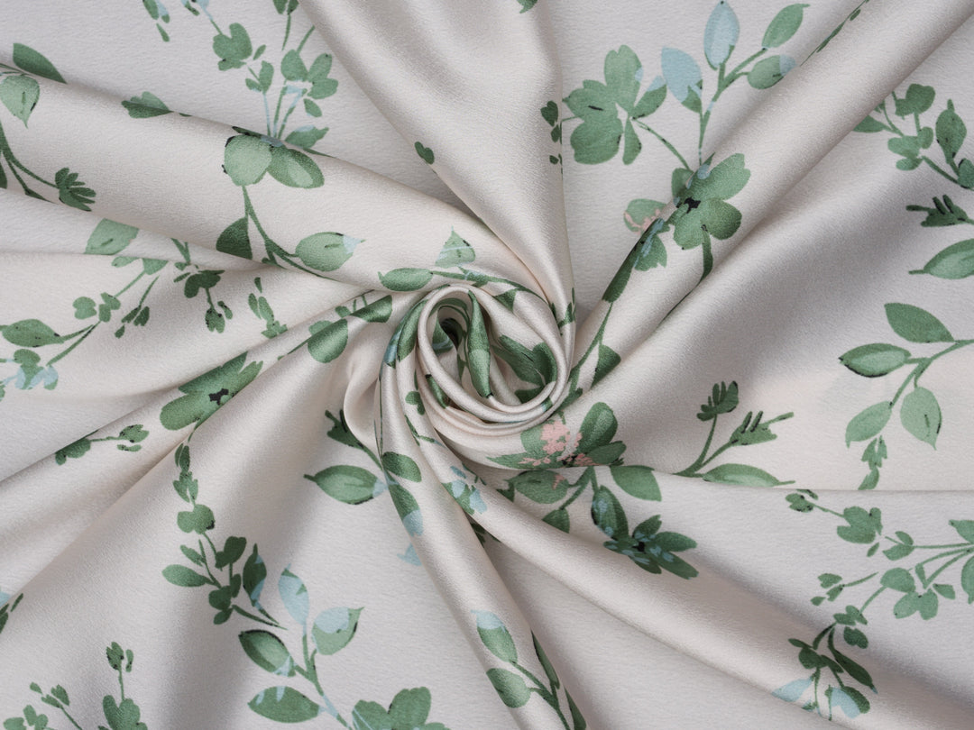 Green floral with blue and pink tones on a light ivory cream satin background 