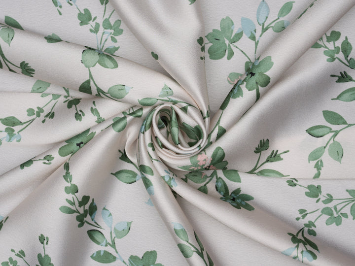 Green floral with blue and pink tones on a light ivory cream satin background 
