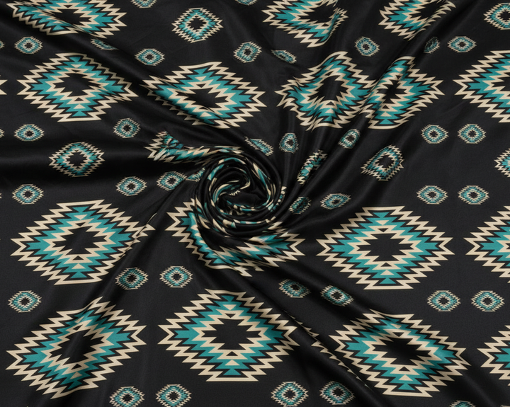 Wide shot of Western Black and Teal Tribal print satin charmeuse fabric with dramatic swirl in center