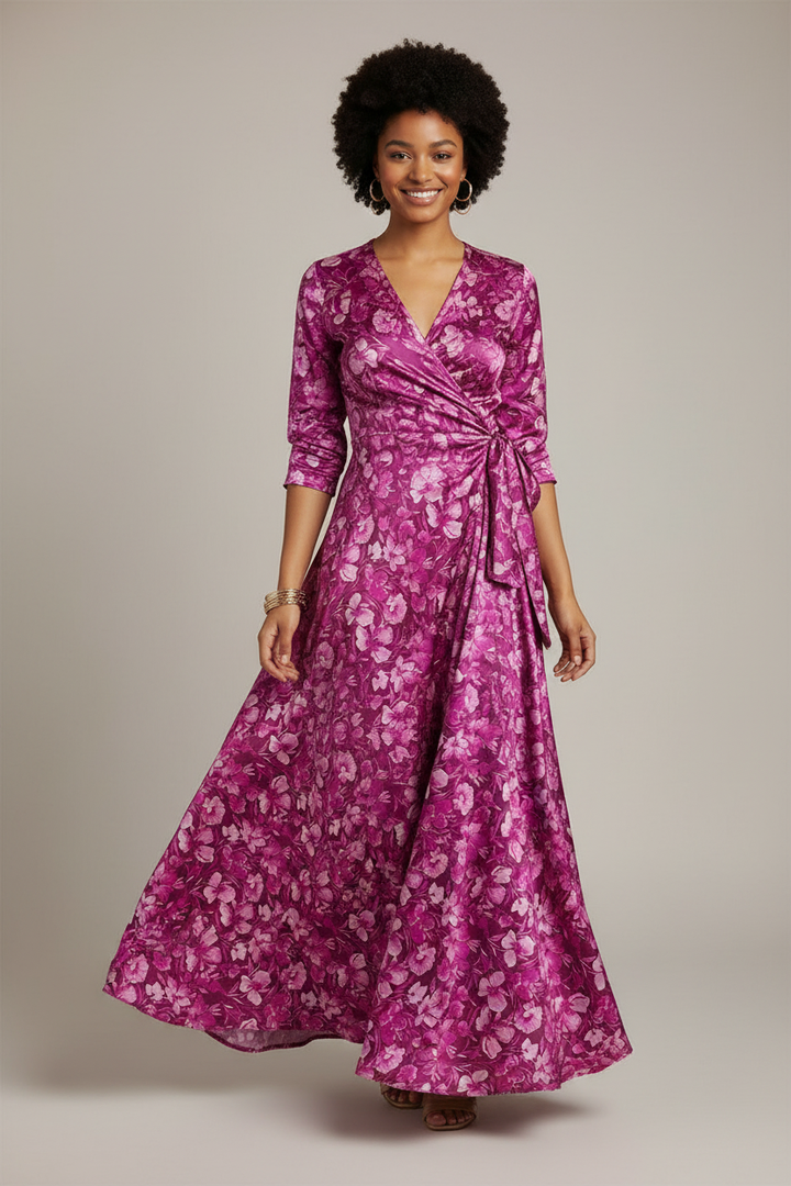 Young African American woman wearing an African-style wrap dress made from magenta floral charmeuse satin fabric