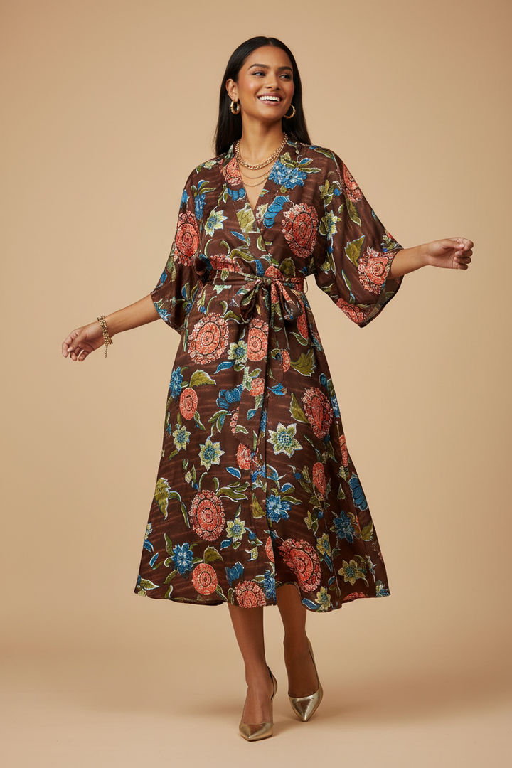 Woman wearing a flowing belted kimono dress made from brown floral print charmeuse satin fabric