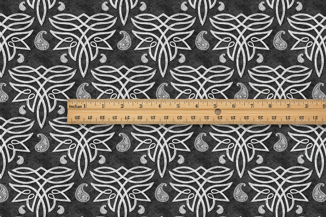 Dark Celtic paisley fabric with wooden ruler showing 3 inch motif scale
