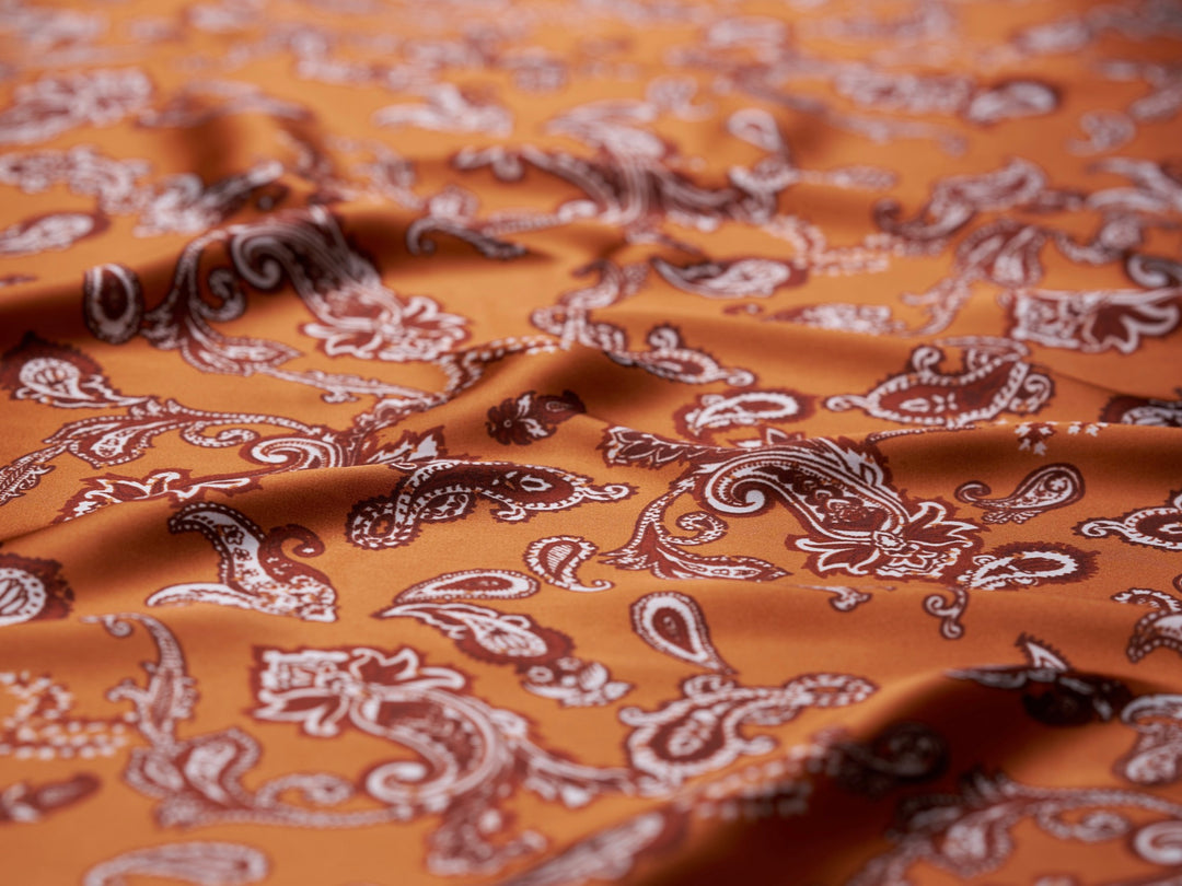 Charmeuse satin fabric by the yard - Burnt Orange distressed paisley   print