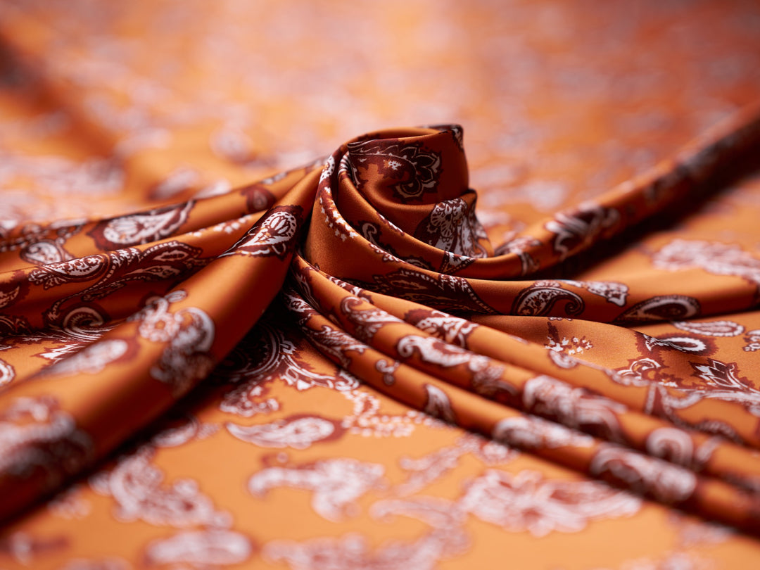 Charmeuse satin fabric by the yard - Burnt Orange distressed paisley   print