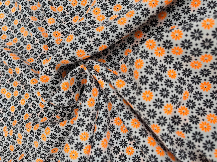 Peachskin  fabric by the yard - orange and black mini flowers